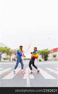 gays with rainbow flag encountering street