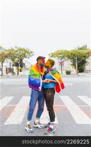 gays with rainbow flag kissing street