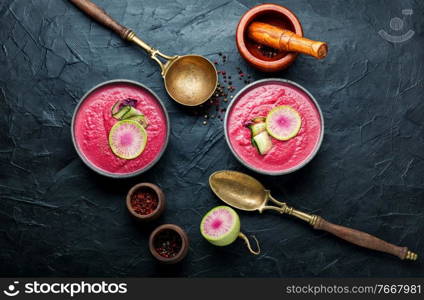 Gazpacho or cold beetroot puree soup with daikon.Vegan food.Top view. Summer beetroot and daikon soup