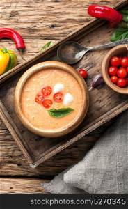 Gazpacho soup with basil. cold Gazpacho soup with tomato on retro wooden background
