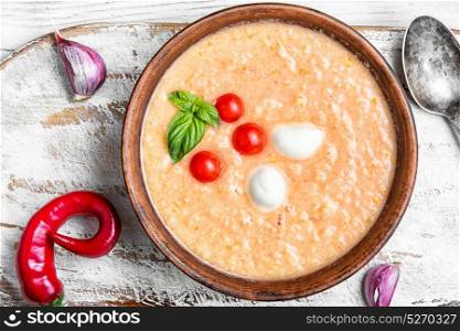 Gazpacho soup with basil. cold Gazpacho soup with tomato on white wooden background