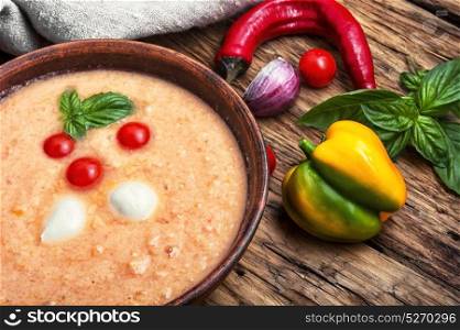 Gazpacho soup with basil. Gazpacho soup with basil on the old wooden background