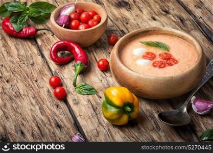 Gazpacho soup with basil. Gazpacho soup with basil on the old wooden background