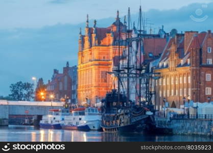 Gdansk. Central embankment at night.. Multi-colored facades and boat on the central waterfront in Gdansk at night.