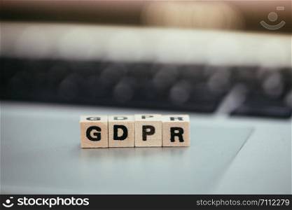 GDPR: Wooden cubes with letters ?GDPR? lying on a laptop. General Data Protection Regulation