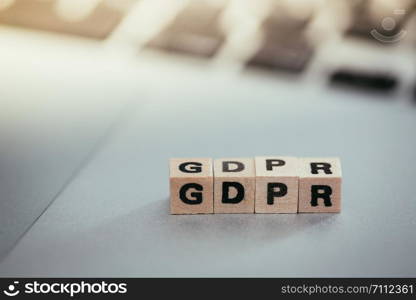 GDPR: Wooden cubes with letters ?GDPR? lying on a laptop. General Data Protection Regulation