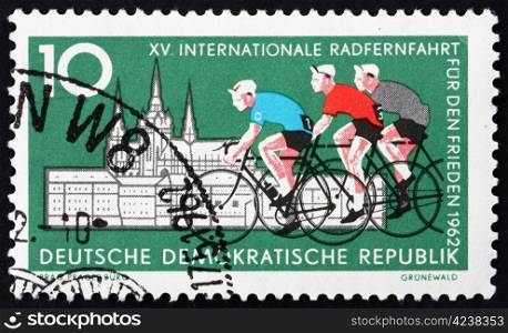 GDR - CIRCA 1962: a stamp printed in GDR shows Cyclists and Hradcany, Prague, 15th International Bicycle Peace, Race, Berlin-Warsaw-Prague, circa 1962