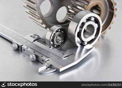 gears and bearings with calipers on a metal plate