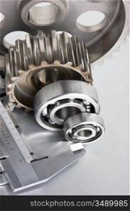 gears and bearings with calipers on a metal plate