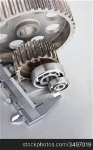 gears and bearings with calipers on a metal plate