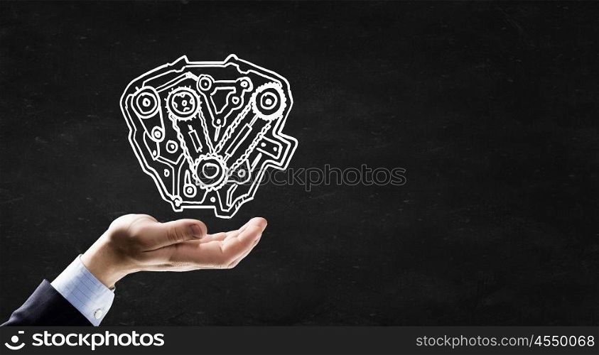 Gears mechanism. Businessman hand holding chalk drawing of gears mechanism