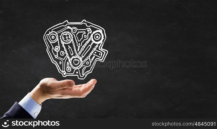 Gears mechanism. Businessman hand holding chalk drawing of gears mechanism