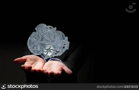 Gears mechanism. Close up of human hand holding gears engine