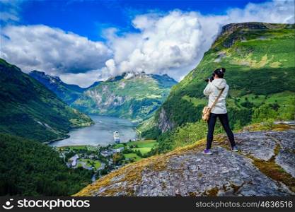 Geiranger fjord, Beautiful Nature Norway panorama. Nature photographer tourist with camera shoots.