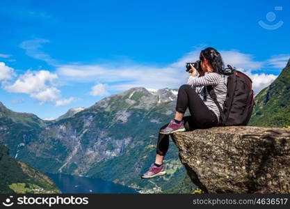 Geiranger fjord, Beautiful Nature Norway panorama. Nature photographer tourist with camera shoots.