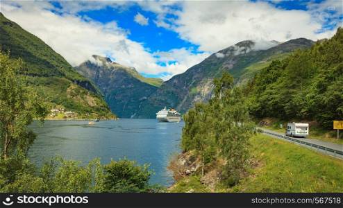 Geiranger fjord with cruise ship and camper car drive eagle road, Norway. Travel in motor home and cruising. Different means of transport.. Cruise ship on fjord and camper on road, Norway.
