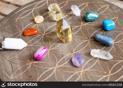Gemstones minerals over life flower chart. Magic healing Rock for Reiki Crystal Ritual, Witchcraft, spiritual esoteric practice. Healing crystals on brown background