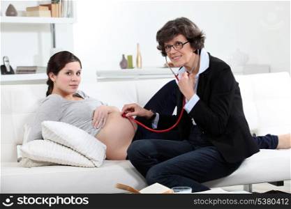 General practitioner and pregnant woman at home