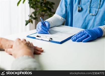 General Practitioner completing patient examination in doctor’s office,filling out medical card form,diagnostic consultation   prevention of women’s diseases,medical service,healthy lifestyle concept