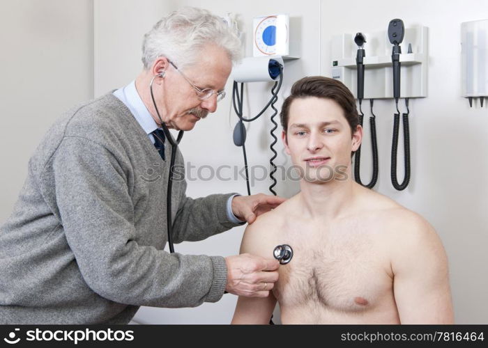General practitioner using a stethoscope to listen to a young patient&rsquo;s chest