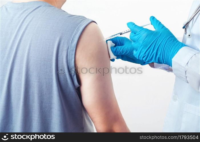General practitioner vaccinating injection immunity Covid-19 vaccine dose to patient muscle arm shoulder on white background. Health and medical concept. Coronavirus epidemic inoculation theme