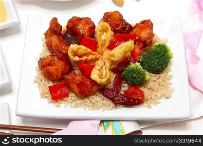General Tso, fried rice, crab rangoon in kitchen or restaurant setting.