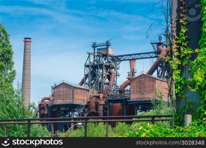 General view of an old industrial plant. General view of an industrial plant refinery, consisting of pipes and towers of heavy industry.