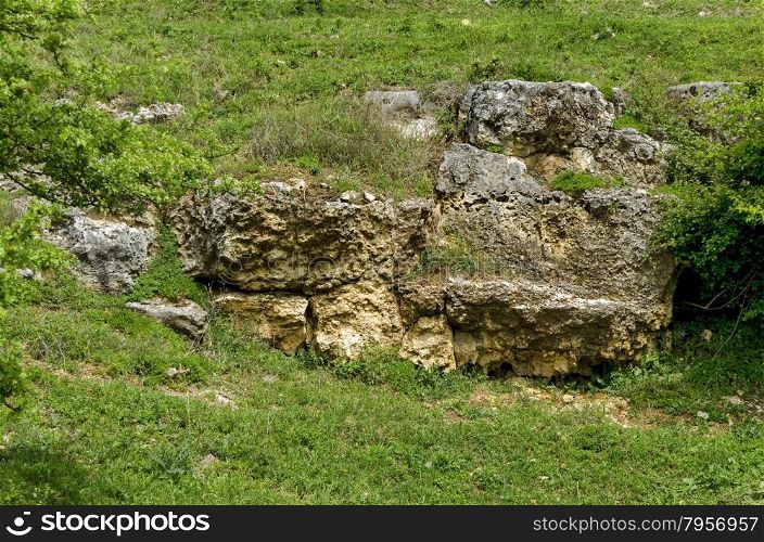 General view toward sedimentary boulder in the field, Ludogorie, Bulgaria