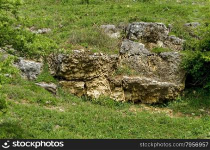 General view toward sedimentary boulder in the field, Ludogorie, Bulgaria