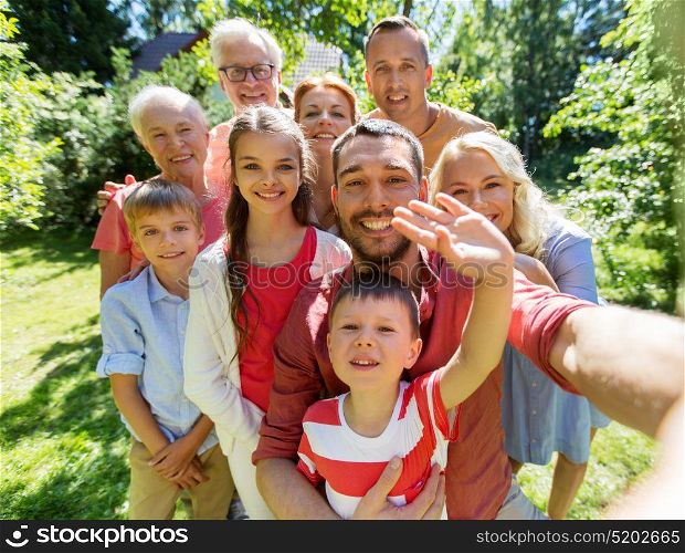 generation and people concept - happy family taking selfie in summer garden. happy family taking selfie in summer garden