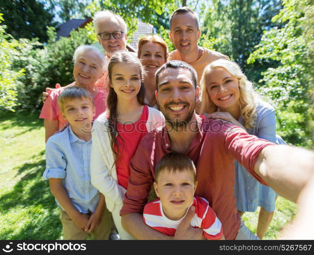 generation and people concept - happy family taking selfie in summer garden. happy family taking selfie in summer garden