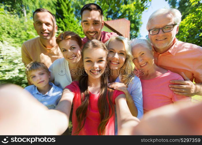 generation and people concept - happy family taking selfie in summer garden. happy family taking selfie in summer garden