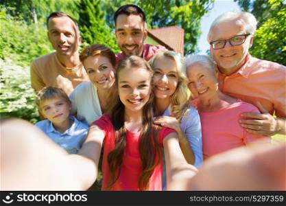 generation and people concept - happy family taking selfie in summer garden. happy family taking selfie in summer garden