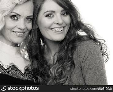 Generation and relationship. Portrait adult daughter with mother. Two attractive elegant women long curly hairs blonde mom and brown haired girl, b&amp;amp;w photo