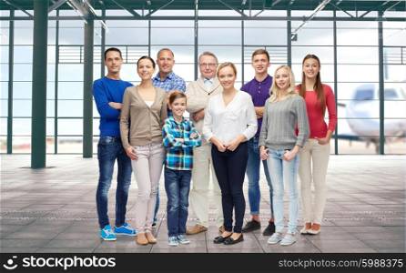 generation, travel, tourism and people concept - big happy family over airport terminal background