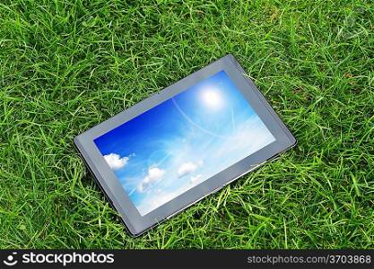 generic tablet computer (tablet pc) on green grass