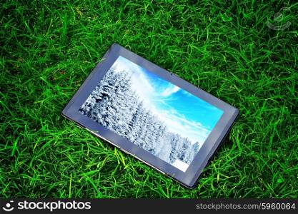 generic tablet computer (tablet pc) on green grass