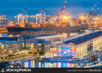 Genoa. Seaport night.. Aerial view of the sea port with night lighting in Genoa at sunset.