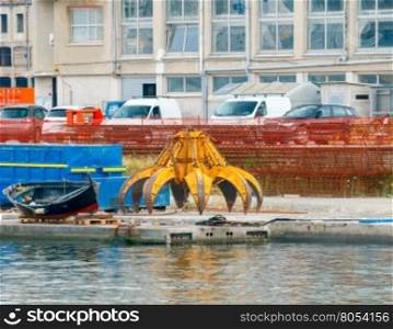 Genoa. The equipment for the crane on the embankment.. Crane grabber for the loading metal scrap.
