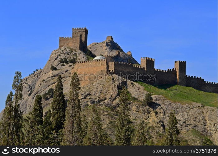 Genoese fortress above the trees in spring