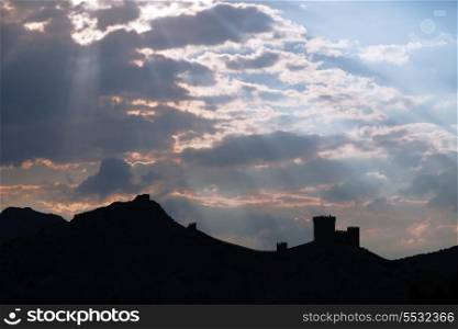Genoese fortress silhouette with blue sky and clouds at sunset&#xA;