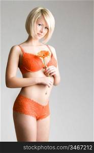 gentle blond posing with flower, studio shot