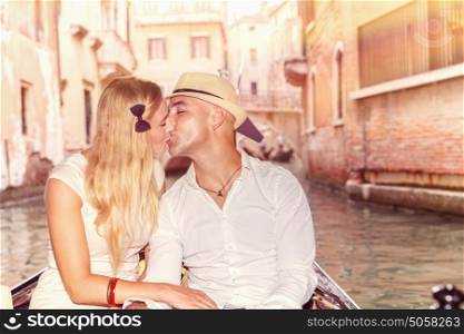 Gentle couple in love, newlywed traveling and kissing in gondola on the water in Venice, romantic relationship, enjoying honeymoon in Italy, Europe