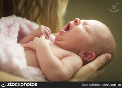 Gentle Hands of Mother Holding Her Precious Newborn Baby Girl.