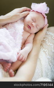 Gentle Hands of Mother Holding Her Precious Newborn Baby Girl.