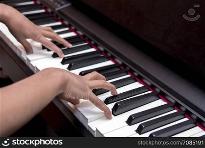 gentle hands playing the piano keys in a concert