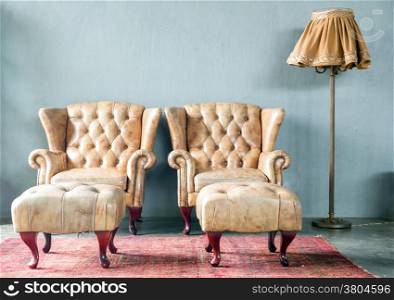 genuine leather classical style sofa in vintage room with desk lamp