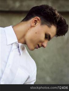 Genuine Sophisticated Young Man in White Shirt Looking Down