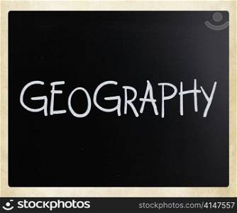 ""Geography" handwritten with white chalk on a blackboard"