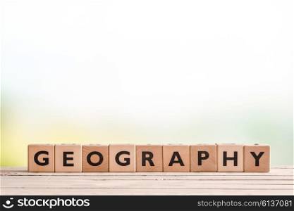 Geography lesson sign made of cubes on a wooden desk